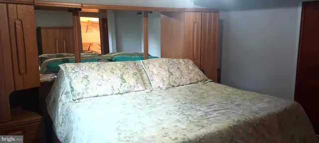 a bed sitting in a bedroom next to a window