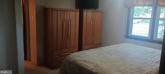 a bed sitting in a bedroom next to a window