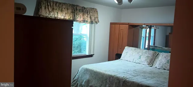 a bathroom with a toilet and a window