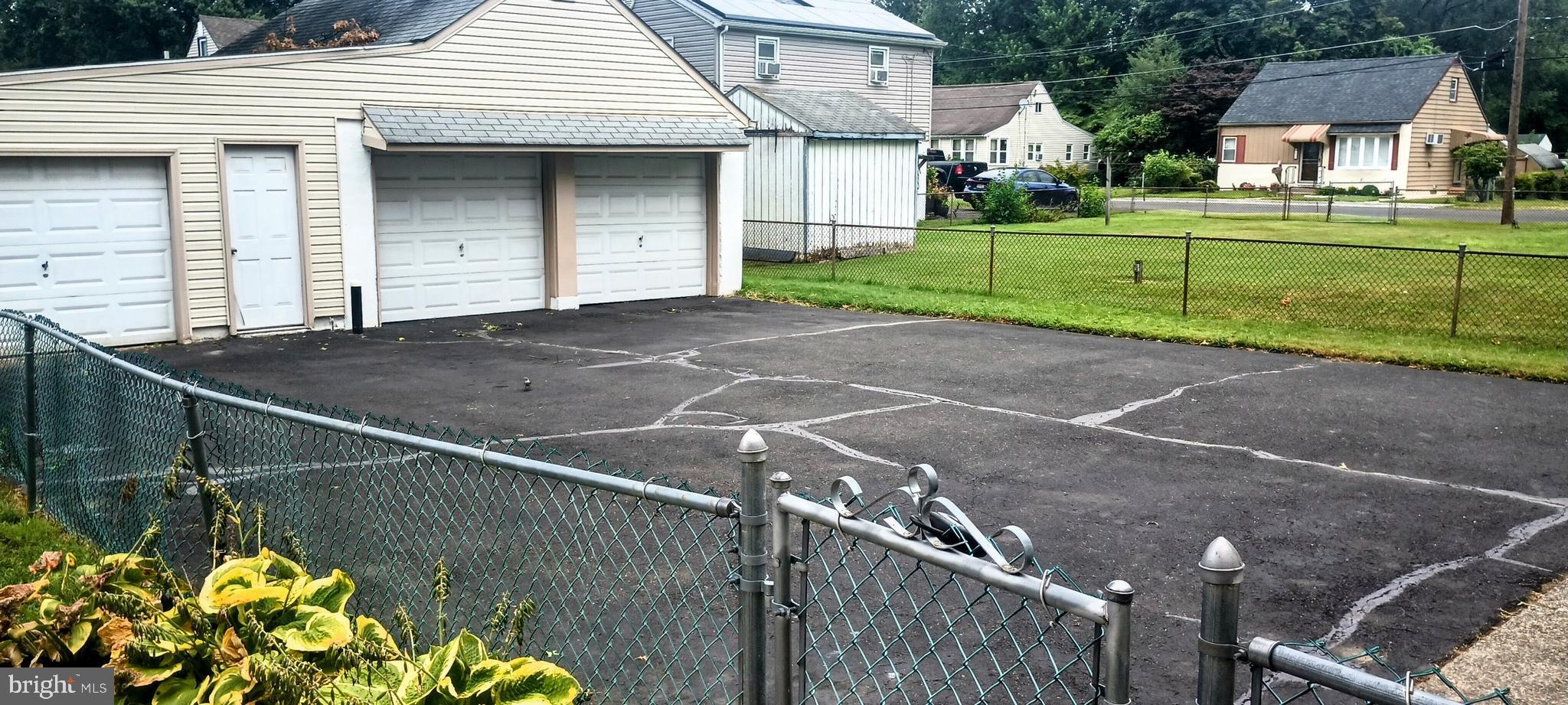 2307 State Rd. Croydon, PA 19021 - Photo 31 of 36 a front view of a house with a yard and a garage