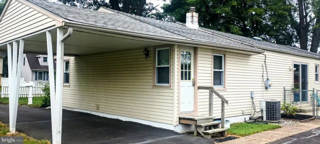a view of a house with a yard and wooden roof