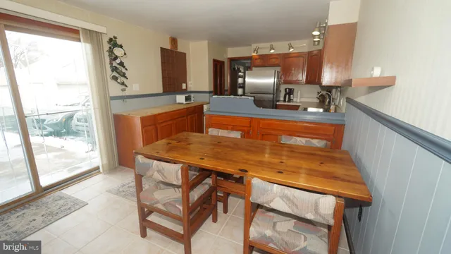 a kitchen with a table chairs in it and wooden floors