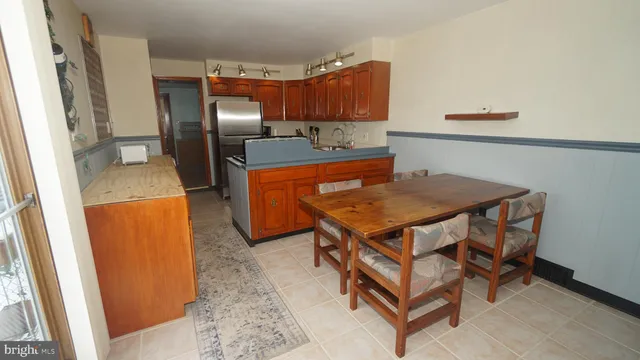 a kitchen with a refrigerator and a stove