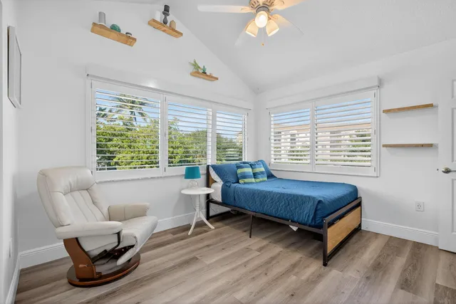 a bathroom with a granite countertop sink and a toilet