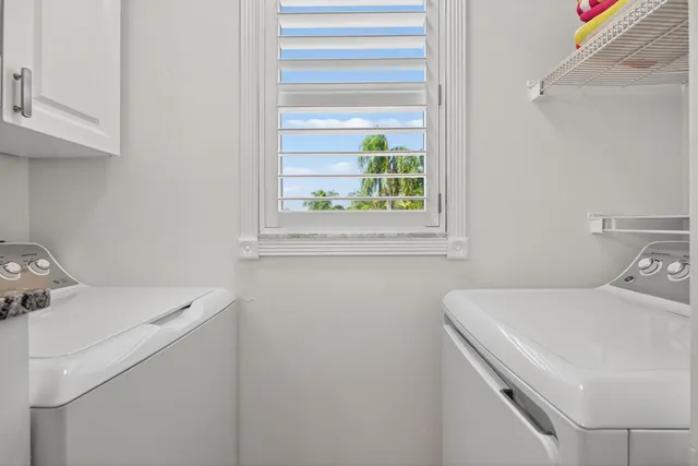 an aerial view of a house with outdoor space lake lake and trees all around