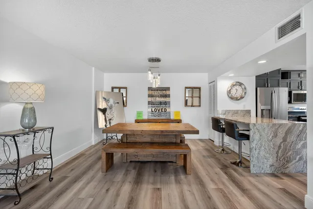 a kitchen with stainless steel appliances granite countertop a refrigerator and a stove