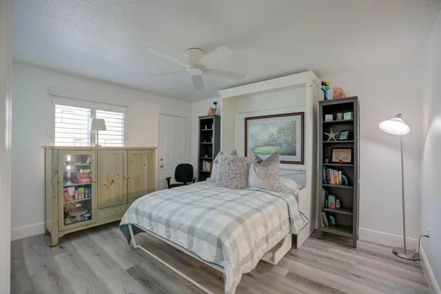 a bedroom with a large bed and a window