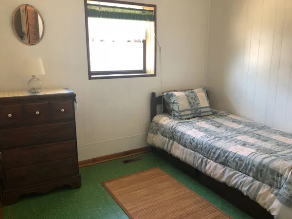 a bedroom with a bed and a window