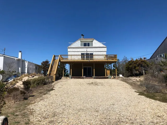 a view of a house with a snow in the background
