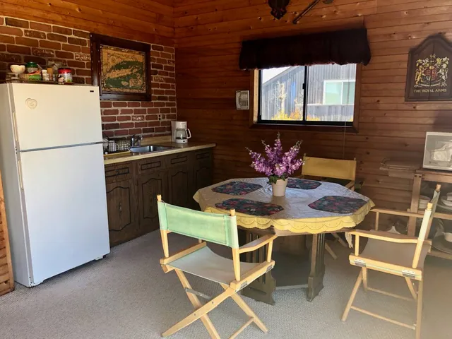 a kitchen with a table chairs and a refrigerator