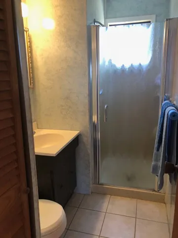 a bathroom with a shower and a toilet
