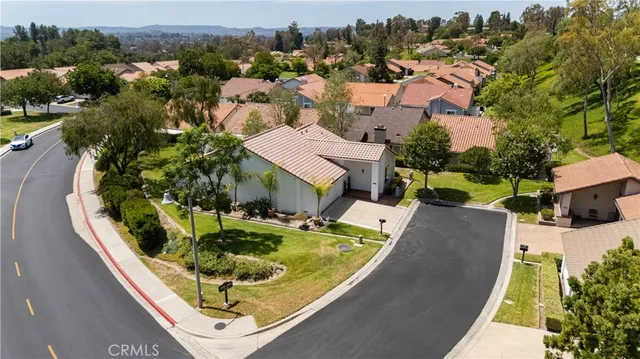 an aerial view of a house with swimming pool patio and lake view