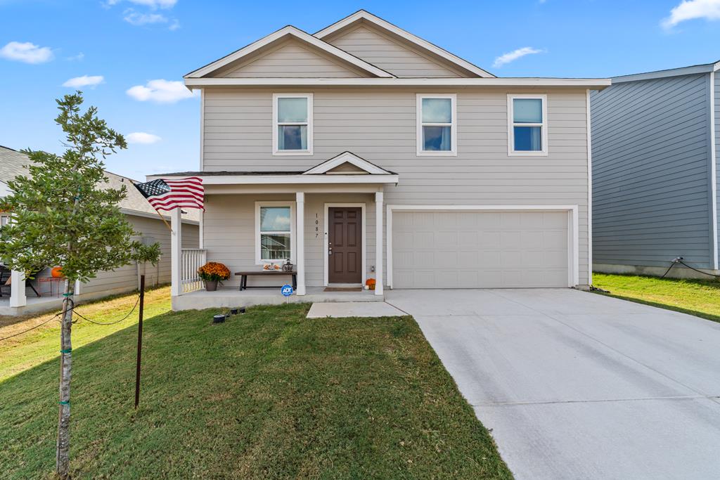 a view of a house with backyard and porch