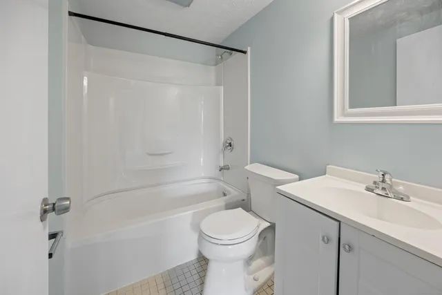a bathroom with a sink a toilet and a bathtub