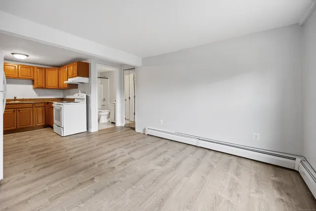 a view of a kitchen with a sink and a refrigerator