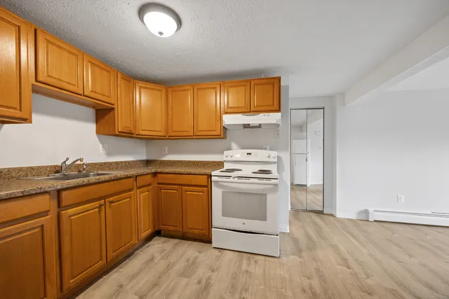 a kitchen with stainless steel appliances granite countertop a sink and cabinets
