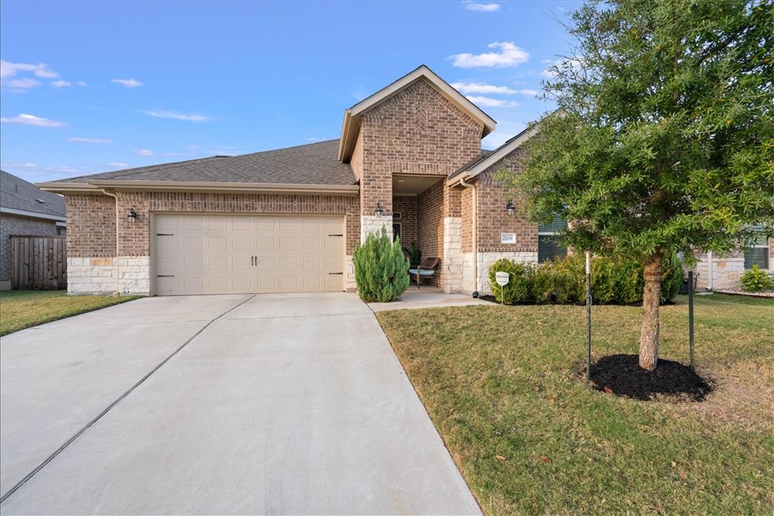 2209 Sauterne Drive Leander, TX 78641 - Photo 1 of 1 a front view of a house with a yard and garage