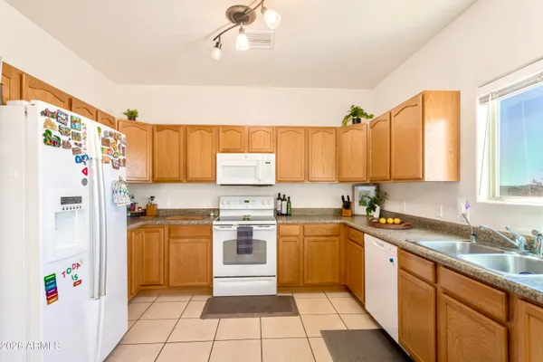 a kitchen with a sink a refrigerator and a stove