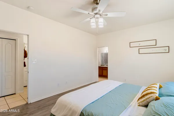 a bedroom with a bed and wooden floor