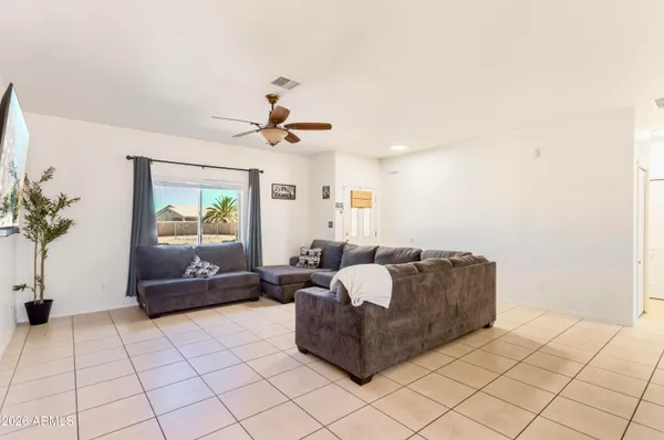 a living room with furniture and a potted plant