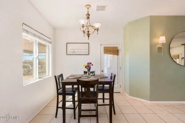 a view of a dining room with furniture and window