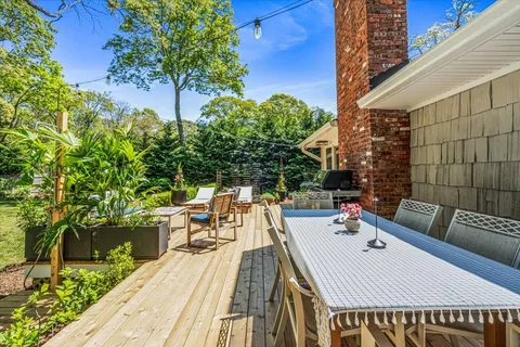 a view of a roof deck with couches and wooden floor