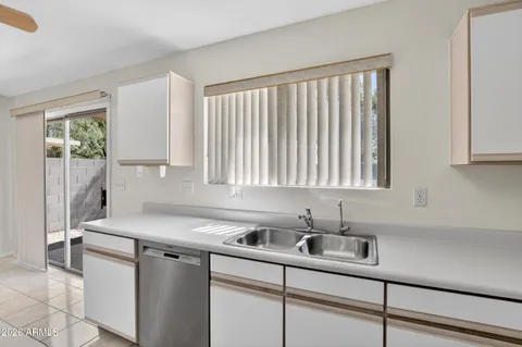a kitchen with a refrigerator a sink and cabinets
