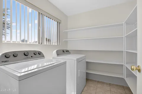 a kitchen with kitchen island white cabinets and refrigerator