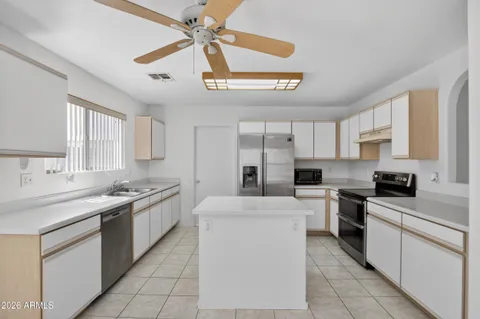 a kitchen with a sink appliances and cabinets