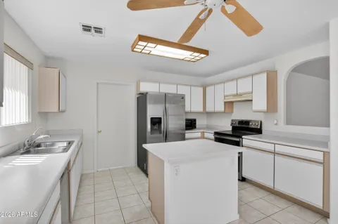 a kitchen with a sink cabinets and window
