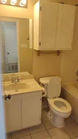 a white toilet sitting next to a bathroom sink