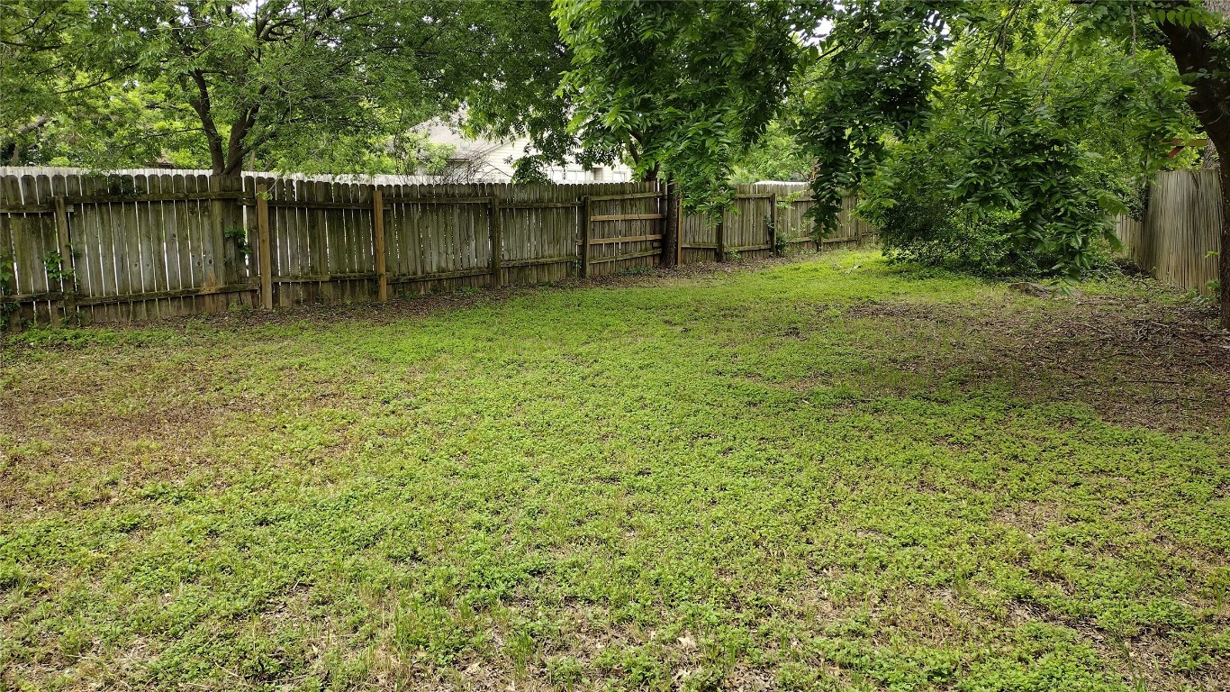 10001 Parliament House Road, Unit A Austin, TX 78717 - Photo 19 of 19 a backyard of a house with lots of green space and lake view