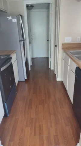a view of a kitchen from a hallway