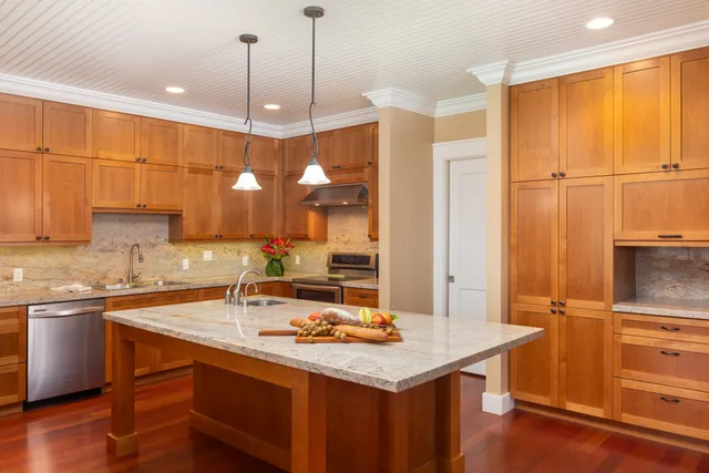 a kitchen with a sink appliances and cabinets