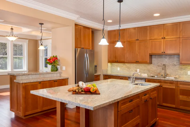 a kitchen with a sink a counter space and a refrigerator