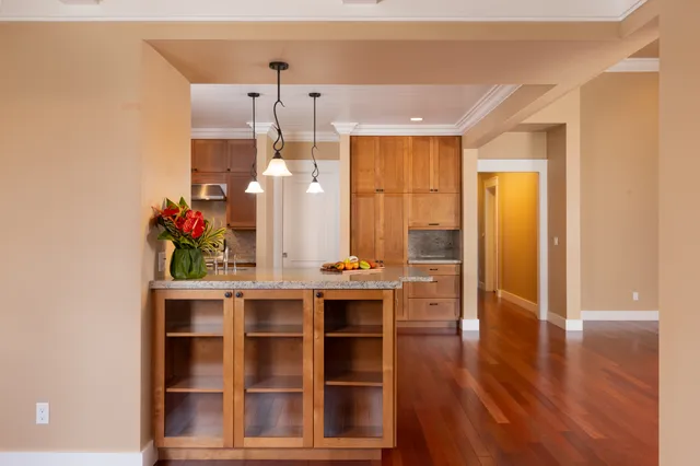 a view of a kitchen with furniture and wooden floor