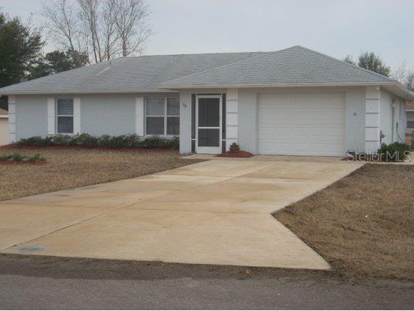 88 Pecan Course Circle Ocala, FL 34472 - Photo 1 of 1 a front view of a house with a yard and garage