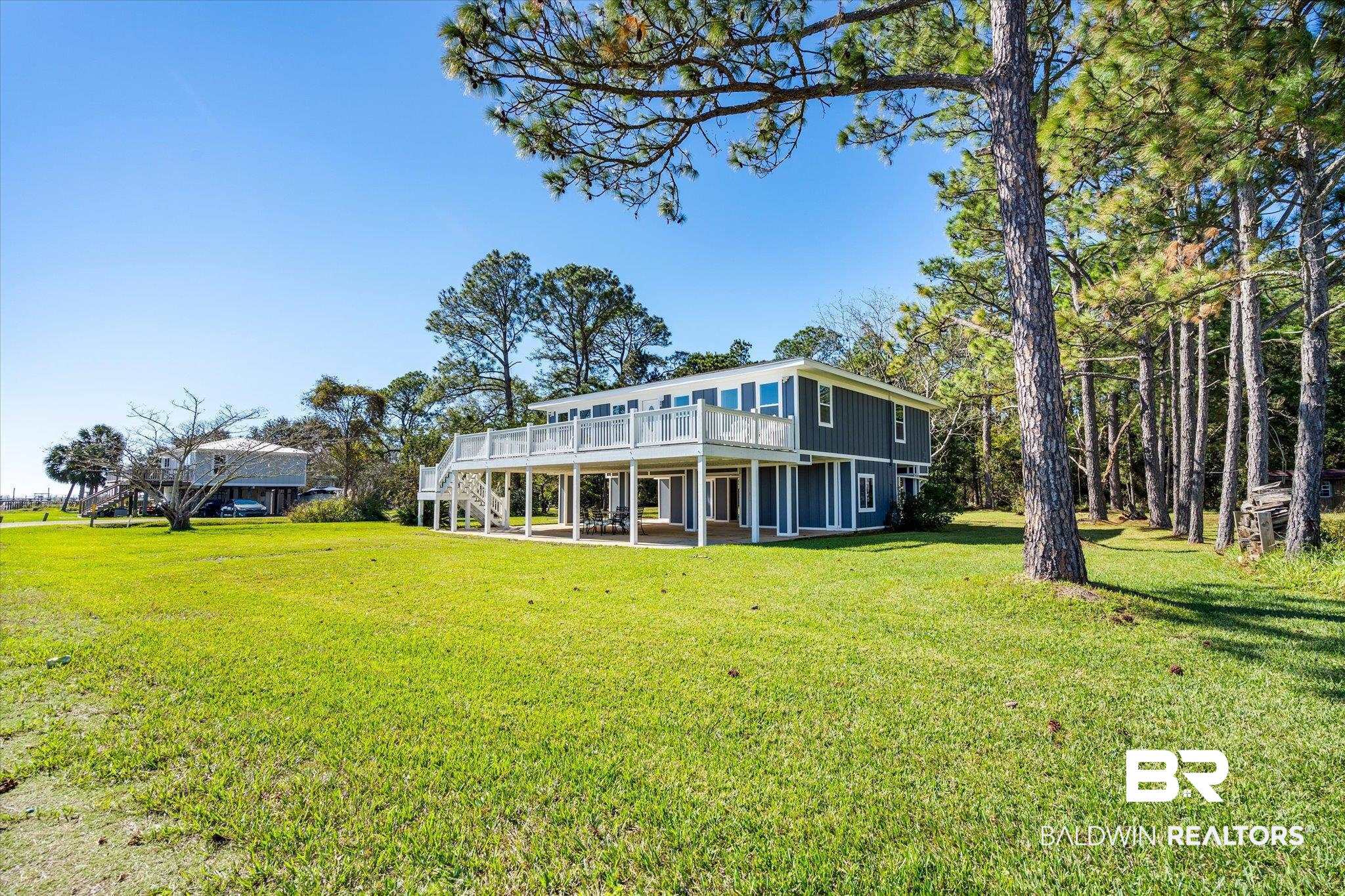 15111 Regus Road Coden, AL 36523 - Photo 21 of 35 Rear view of property with a patio area, a lawn, a wooden deck, and stairs