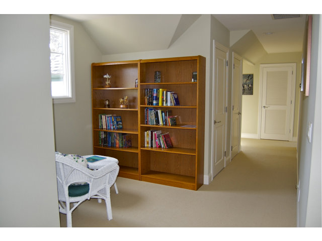 18 Ashdown Place Half Moon Bay, CA 94019 - Photo 16 of 23 a living room with a chair and a book shelf