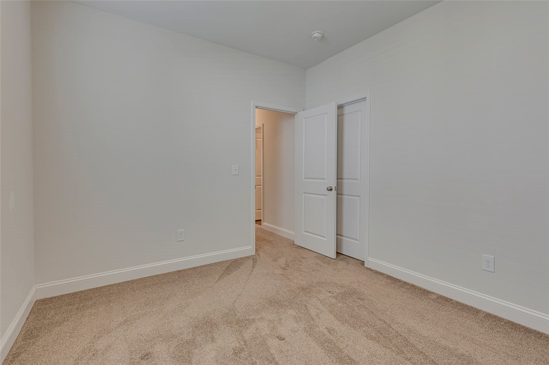 141 Capslock Trail Pendleton, SC 29670 - Photo 14 of 38 A spacious, naturally illuminated room features plush carpeting and crisp white trim.