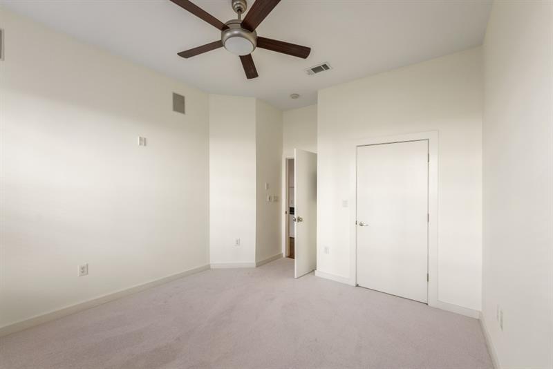 870 Inman Village Parkway Northeast, Unit 203 Atlanta, GA 30307 - Photo 14 of 43 an empty room with windows and fan