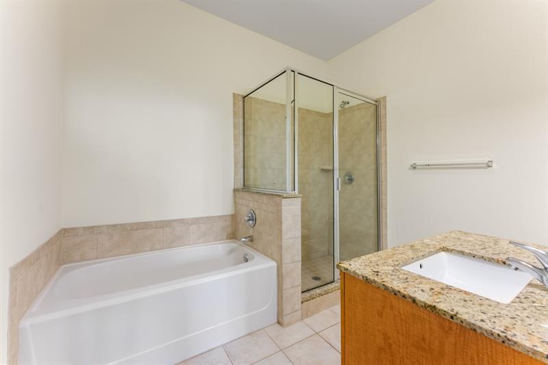 870 Inman Village Parkway Northeast, Unit 203 Atlanta, GA 30307 - Photo 16 of 43 a bathroom with a granite countertop sink and a bathtub