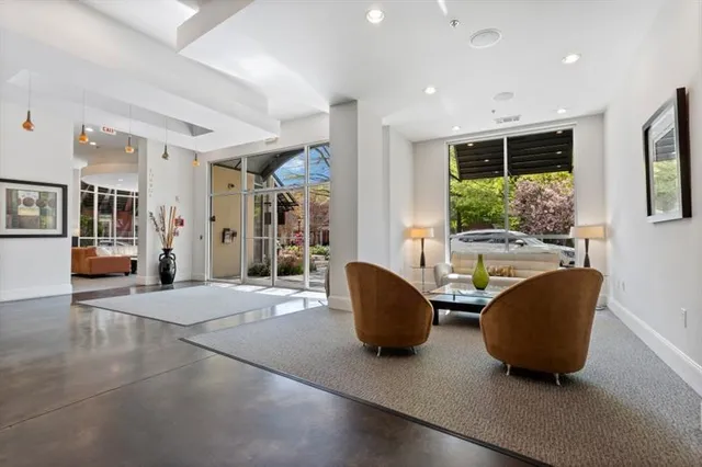 a living room with furniture and a chandelier