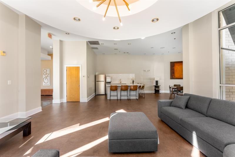 870 Inman Village Parkway Northeast, Unit 203 Atlanta, GA 30307 - Photo 22 of 43 a living room with furniture and a chandelier