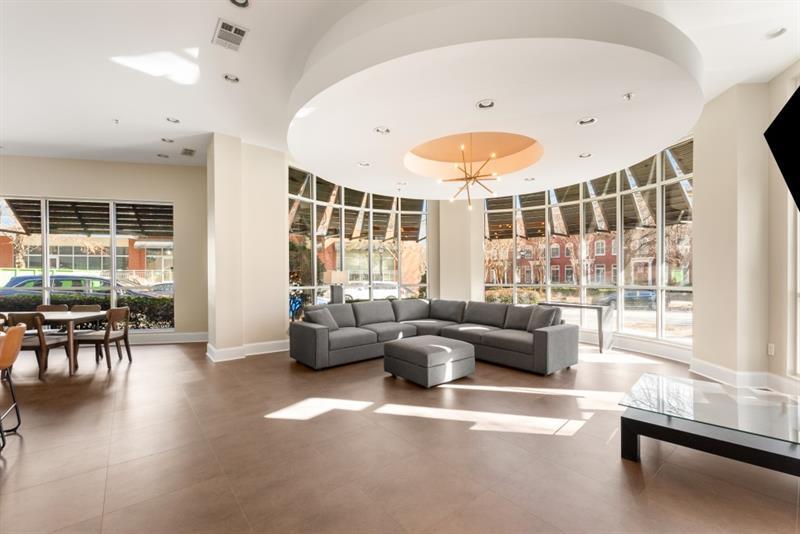 870 Inman Village Parkway Northeast, Unit 203 Atlanta, GA 30307 - Photo 24 of 43 a living room with furniture and a large window