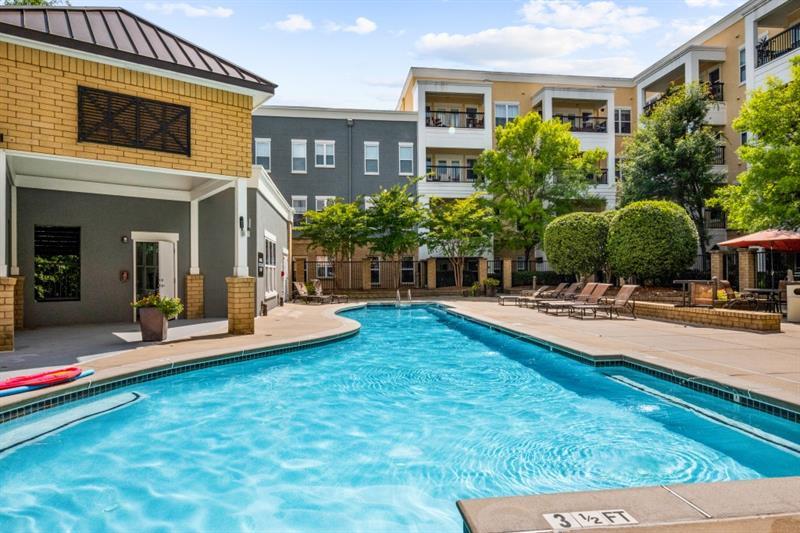 870 Inman Village Parkway Northeast, Unit 203 Atlanta, GA 30307 - Photo 27 of 43 a swimming pool with outdoor seating and yard