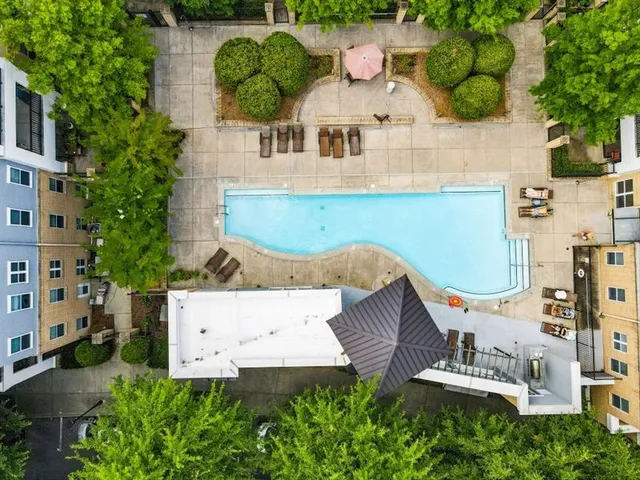 a aerial view of a multi story building with a yard