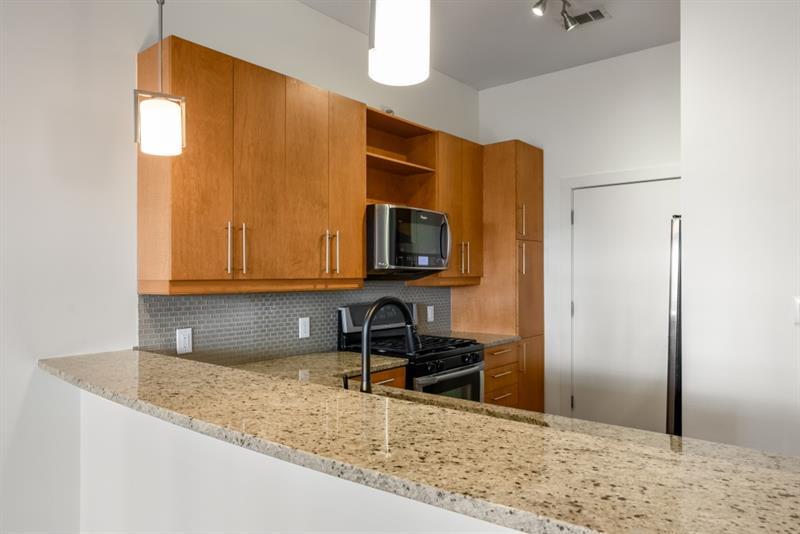 870 Inman Village Parkway Northeast, Unit 203 Atlanta, GA 30307 - Photo 4 of 43 a kitchen with a sink a stove and a refrigerator