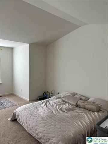 a bedroom with a bed and pillows