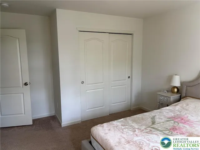 a bedroom with a bed and a table